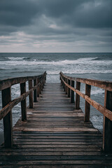 Fototapeta premium Wooden pier with crashing waves