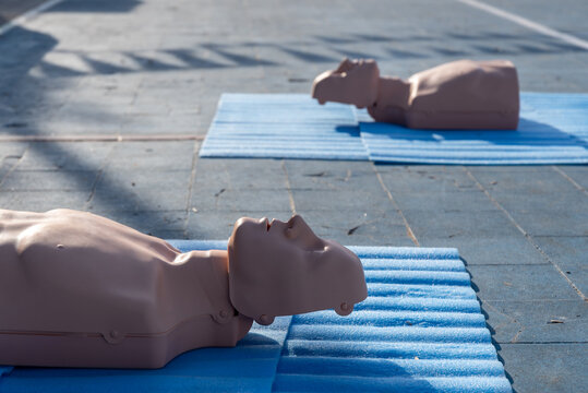 Group of CPR training mannequins on a floor for a first aid and resuscitation class