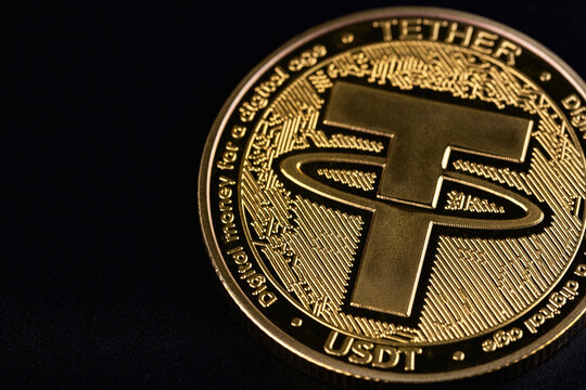 USDT, Tether cryptocurrency symbol on a black background. Tether is a cryptocurrency token issued by Tether Limited. Batumi, Georgia - March 18, 2026