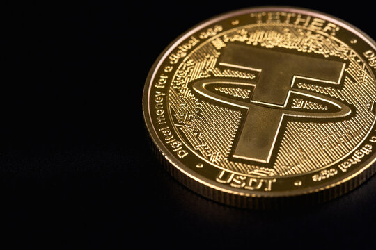 USDT, Tether cryptocurrency symbol metal coin on a black background. Tether is a cryptocurrency token issued by Tether Limited. Batumi, Georgia - March 18, 2026