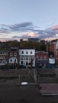 London, UK - April 20 2026: Vertical view of historic London pubs and Thames riverside at sunset