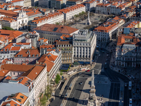 Aerial view of Rossio Square and Restauradores Square with historic red-roofed buildings and the Monument to the Restorers in Lisbon, Lisbon, Portugal.