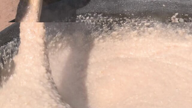 Close-up of Stirring Steaming Bogobe in a Traditional Cooking Pot with bogobe or pap.