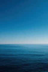 Fototapeta premium Clear blue sky meets calm ocean waters