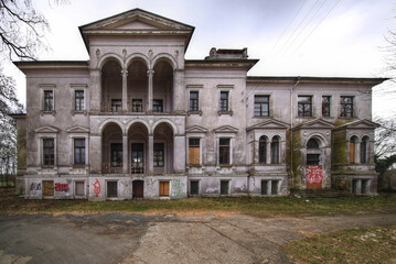 Fototapeta premium Abandoned historic mansion facade of Schloss Randau in Germany with columns boarded windows and graffiti