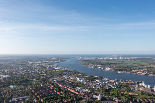 High-altitude drone panorama over Warnem&uuml;nde showing beach, harbor, lighthouse, Teepott and the Baltic Sea coastline, Rostock, Germany