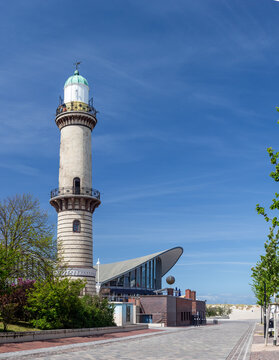 Iconic Warnem&uuml;nde lighthouse tower rising above the Teepott modernist building on the Baltic Sea promenade, Rostock, Germany