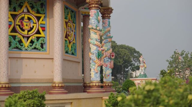 Decorative column and facade detail of Cao Dai Temple static shot in Tay Ninh Vietnam