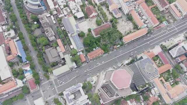 HO CHI MINH CITY, VIETNAM - 2022 ARCHIVE: Bird's-eye view of urban traffic and lush green trees at Dinh Tien Hoang - Le Duan crossroad