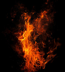 Fototapeta premium Burning Ember Dance: A mesmerizing display of fire, its vibrant orange and yellow flames against a stark, black backdrop, creating a captivating spectacle of heat and energy.