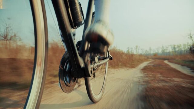 Cyclist Riding Bike On Dirt Path Through Autumn Field. Cycling Workout And Active Lifestyle 