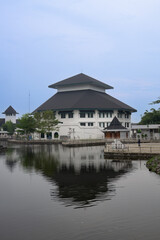 Fototapeta premium Modern Javanese architecture building with water reflection at Embung Giwangan, Yogyakarta