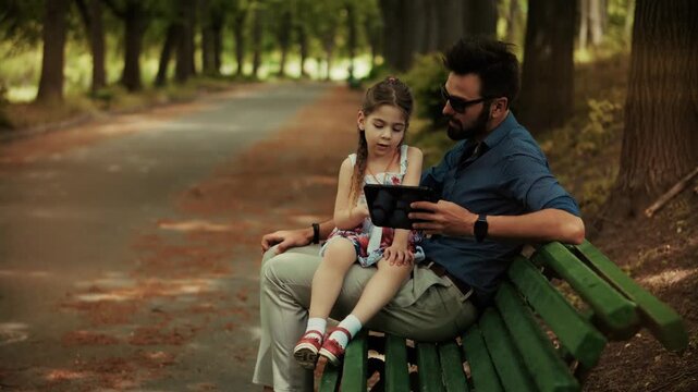 Father Showing Tablet Screen To Kid. Modern Technology Integration In Family Life. Digital Education And Leisure