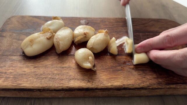 Slicing squid rings cutting board and knife tasty snack fresh gourmet food background rustic food on a table, top view copy space pescetarian diet