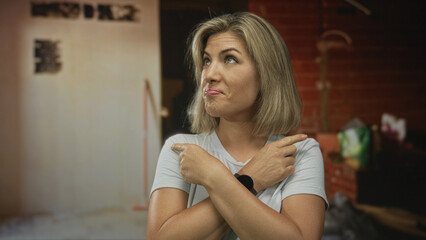 Naklejka premium Woman points finger in building with exposed brick wall and scattered tools inside; uncertainty dilemma.