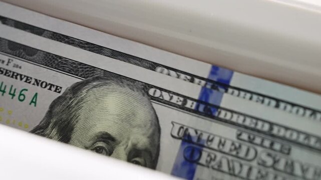 Automatic bank equipment counting stack USD hundred dollar bills close up view. Financial transaction processing cash money accounting technology. Business success wealth management banking operations