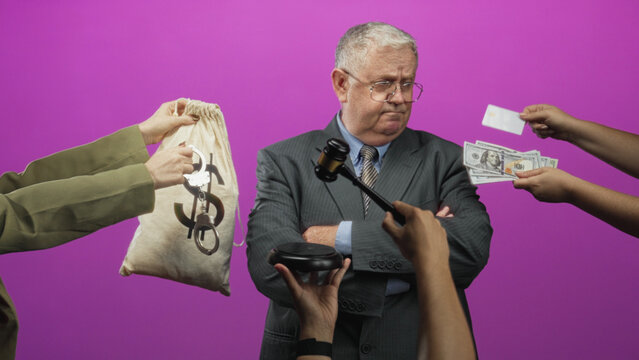 Man in suit with arms crossed, hands offering cash and a money bag with dollar and handcuffs while a gavel is presented in studio; corruption guilt scandal.