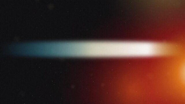 Abstract light leak effect showcasing a bright horizontal color gradient from cool blue to warm orange on dark grain