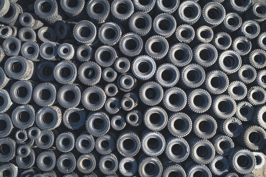 Aerial view of a vast collection of used rubber tires stacked in an industrial recycling facility with various sizes and tread patterns Santa Lucia de Gordon, Castile and Leon, Spain.