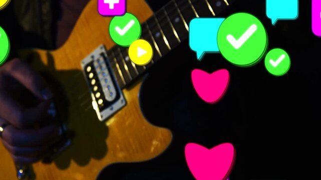 Vertical video: Player fretting and plucking, green check causing icons over guitar for music