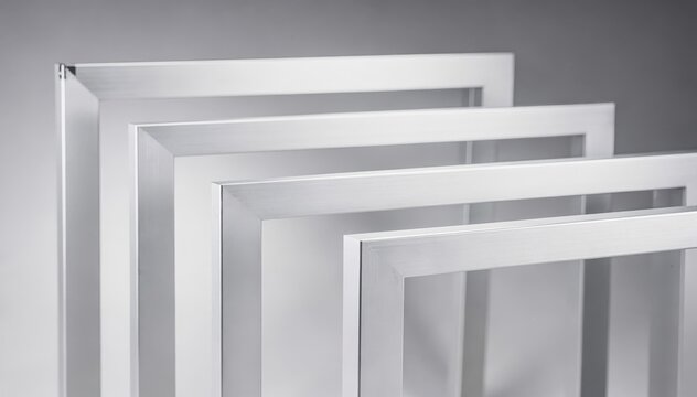 Medium shot of anodized aluminum frames with clear electrochemical finishing showcasing smooth protective surfaces enhancing corrosion resistance under bright lighting.