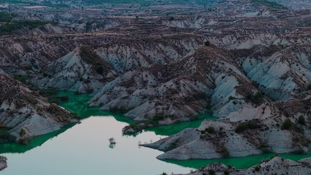 Aerial view of the librilla reservoir badlands and its emerald green waters