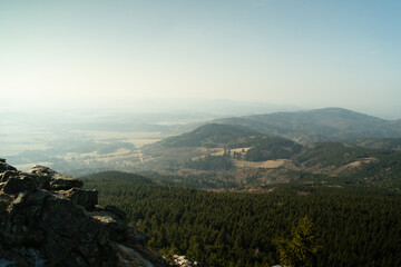 Obraz premium Panoramic view of dense forest hills and nature landscape from Jested mountain in Liberec Czech Republic Europe. Scenic travel destination for tourism and commercial use.