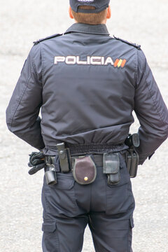 Spanish police officer from behind The Concept of Law