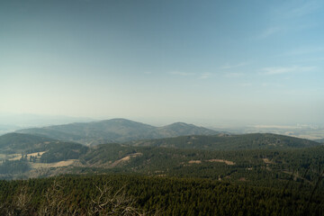 Obraz premium Panoramic view of dense forest hills and nature landscape from Jested mountain in Liberec Czech Republic Europe. Scenic travel destination for tourism and commercial use.