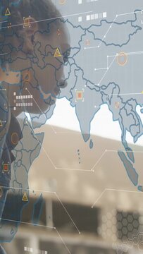 Vertical video: Woman leaning and turning head while world-map HUD fading in, reacting to tech data