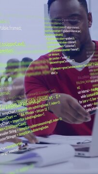 Vertical video: Man in red top handing pen, pointing at docs for tech code review, overlay rising