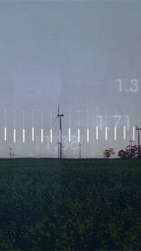 Vertical video: Sunrise starting main turbine rotating while data bars pulsing to monitor output