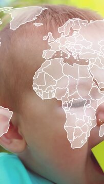 Vertical video: Hands placing cube and yellow block baby mouthing for health as map panning face