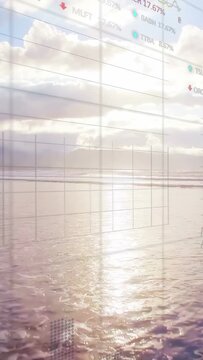 Vertical video: Wet sand mirroring sun finance grid rising as camera panning causing market charts