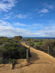 Fototapeta premium Scenic coastal pathway under a blue sky