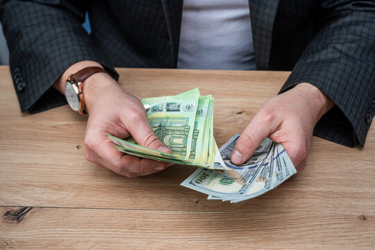 Businessman Hands Counting US Dollar and Euro Banknotes for Currency Exchange and Investment