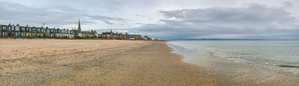 Empty east end of Portobello beach in Edinburgh, overcast autumn day, Joppa parish church tower visible at distance
