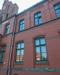 Fototapeta premium Ludwigslust brick facade with green windows reflecting architecture
