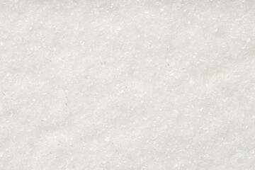 Naklejka premium White granulated sugar as background, top view