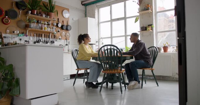 Young friends chatting in a cosy kitchen setting