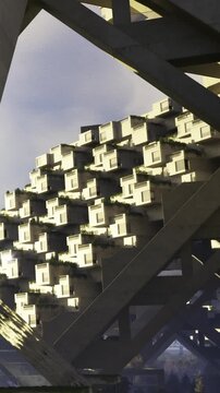 A striking view of contemporary building design showcases unique geometric patterns. Sunlight casts gentle shadows, creating an intriguing play of light and texture on the structure.