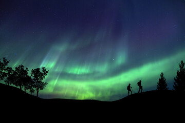 A person is observing a magnificent Aurora Borealis light display in an open field Success concept. © Philip