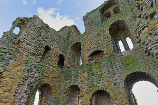 Close-up of ancient castle ruins, revealing weathered stone walls with arched windows  in Scarborough Castle - Yorkshire - Great Britain