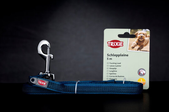 Trixie 5 meter dog leash tracking lead with metal hook and packaging on dark background. Pet accessory for training and outdoor use shown as illustrative editorial content.