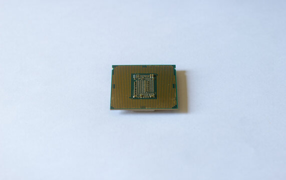 Close-up of a person holding a gold-plated computer CPU microchip in their palm. Concept of technology, computing power, hardware, and digital innovation.