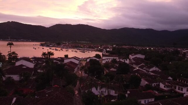 Pink sunset over Paraty coastline with ocean and mountains in Rio de Janeiro Brazil