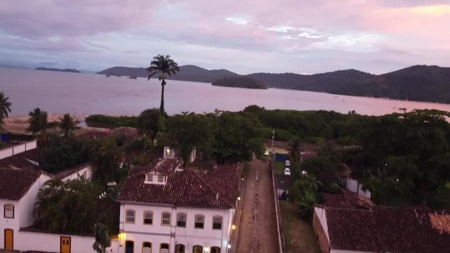 Pink sunset over Paraty coastline with ocean and mountains in Rio de Janeiro Brazil