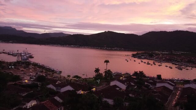 Pink sunset over Paraty coastline with ocean and mountains in Rio de Janeiro Brazil