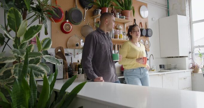 Roomies socialising over coffee in their kitchen