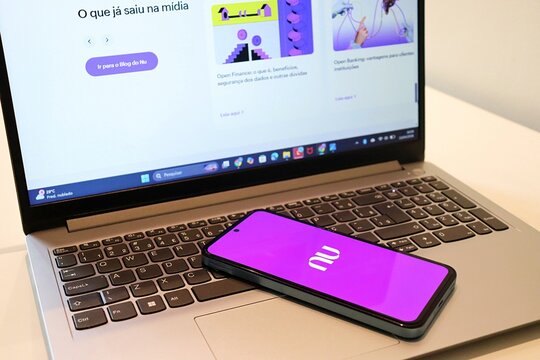 Salvador, Brazil - April 14, 2026: Nubank app on smartphone screen and Nubank website in the laptop. 